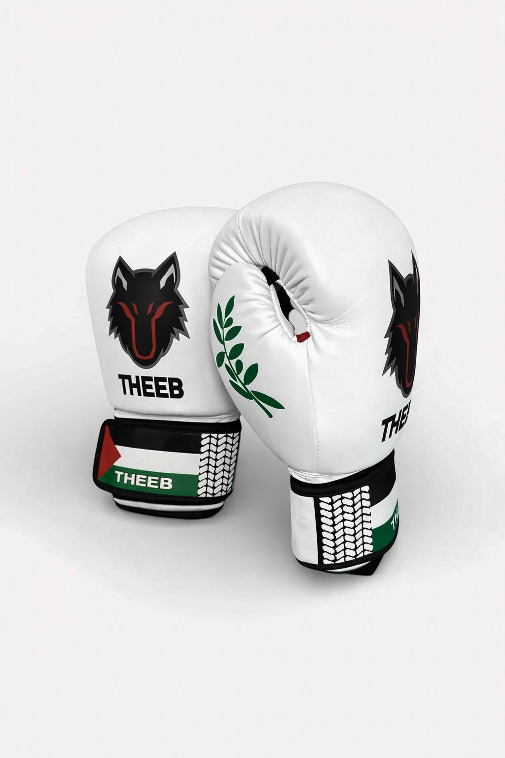 THEEB Falastini boxing gloves in white PU leather with black wolf logo and Palestinian flag detail on wrist strap.