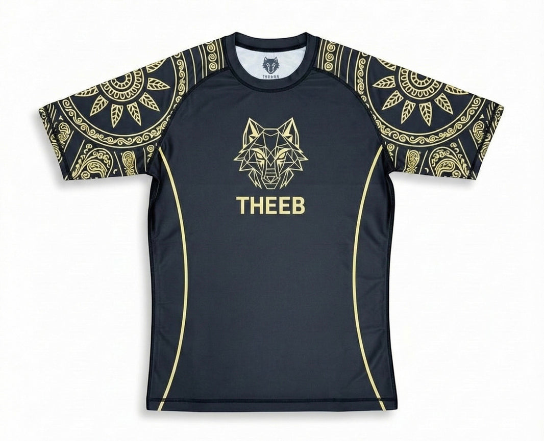 My Store THEEB Golden Age black rash guard with gold geometric wolf logo and ornate sleeve designs. Compression fit for BJJ, MMA, and training.