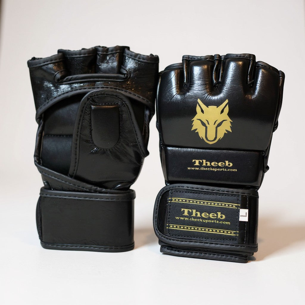 Theeb Golden Age kids MMA gloves in black genuine cowhide leather with open finger design and gold wolf logo.