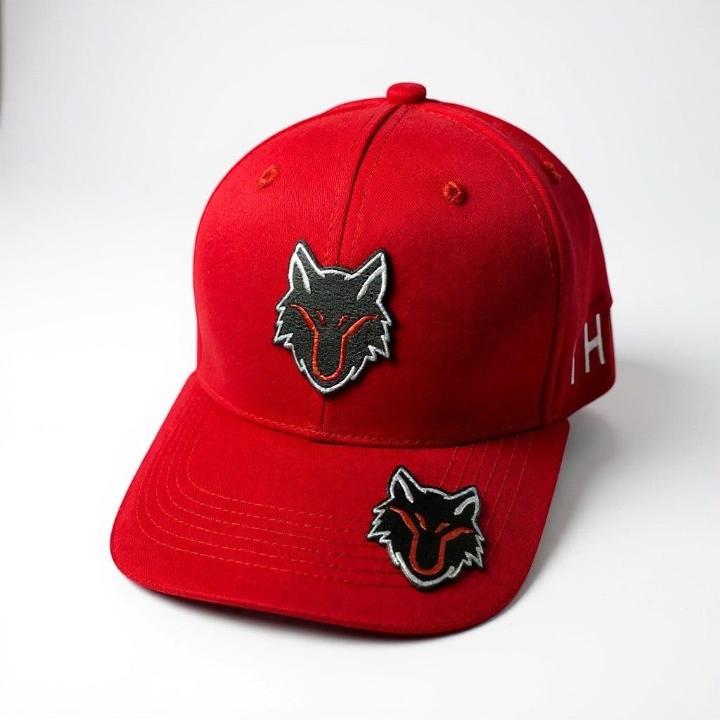 My Store red baseball cap with dual black wolf head logos on front and brim. Adjustable strap.