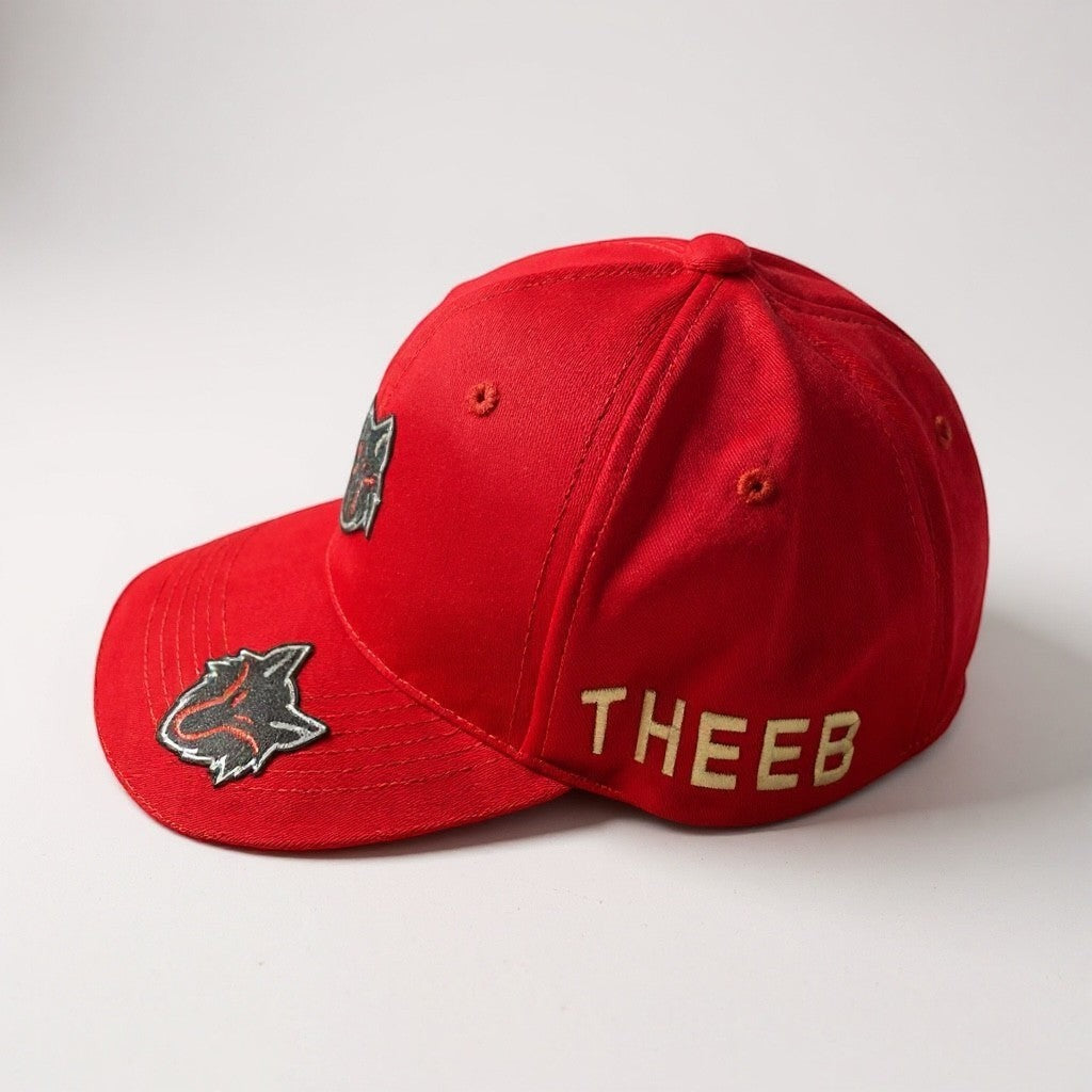 My Store red cotton baseball cap with dual THEEB wolf head logos and embroidered "THEEB" text.
