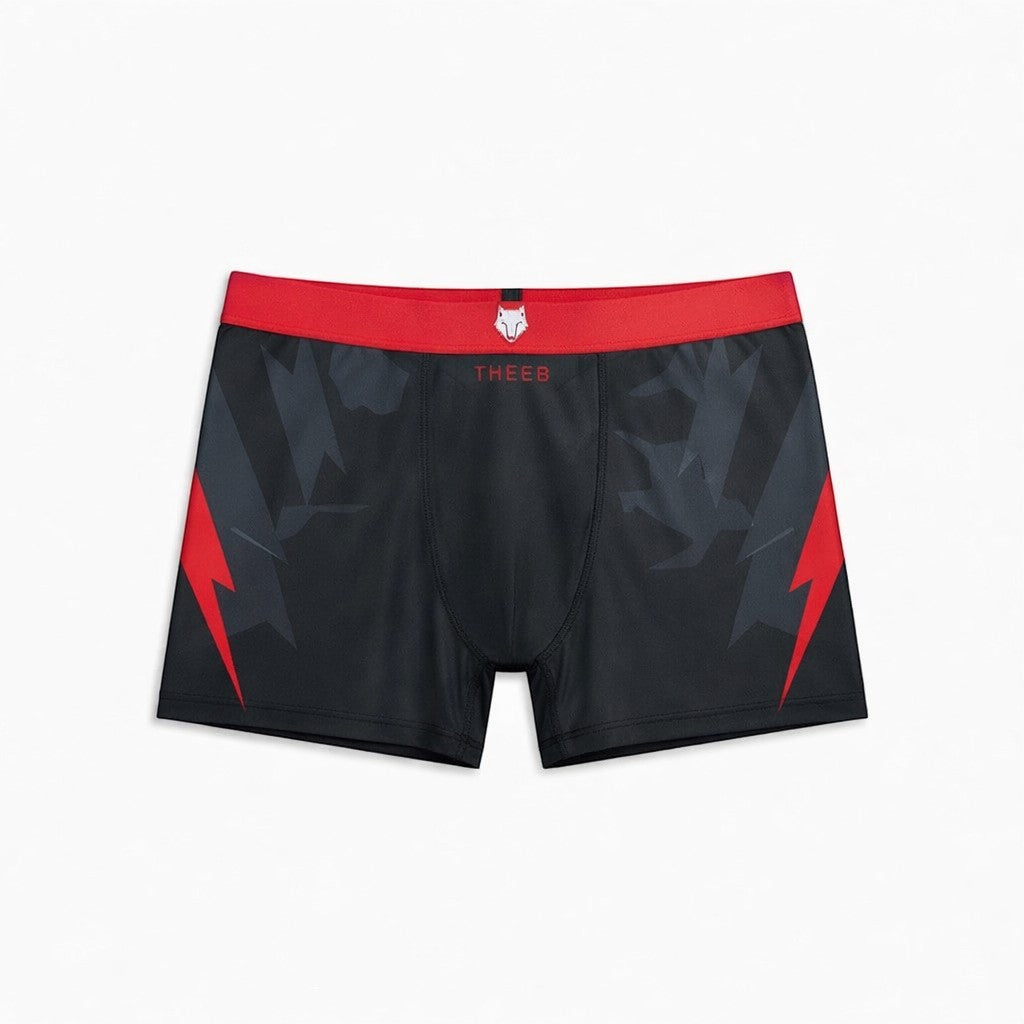 THEEB black compression shorts with red lightning bolt accents and red waistband.