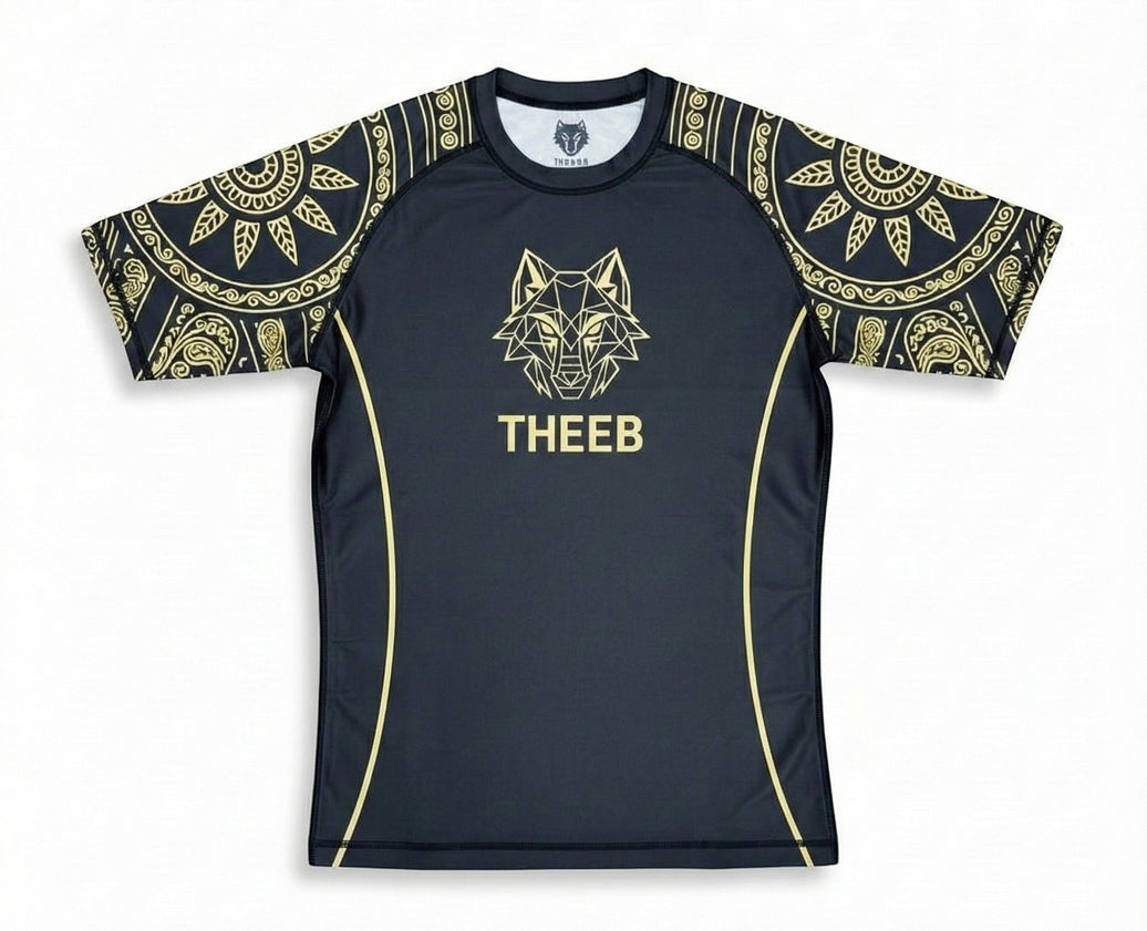 My Store THEEB Golden Age black rash guard with gold geometric wolf logo and ornate sleeve designs. Compression fit for BJJ, MMA, and training.