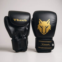 My Store black genuine leather Muay Thai gloves for kids with gold wolf logo and Theeb branding.