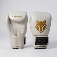 My Store Theeb Golden Age kids Muay Thai gloves in off-white genuine leather with gold wolf logo and secure wrist strap.