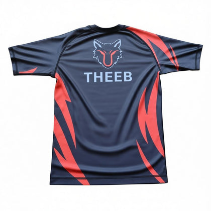 My Store THEEB Back to Basics Kids Rash Guard, dark grey with red flame accents and wolf logo. Short sleeve, breathable, stretchy fabric.