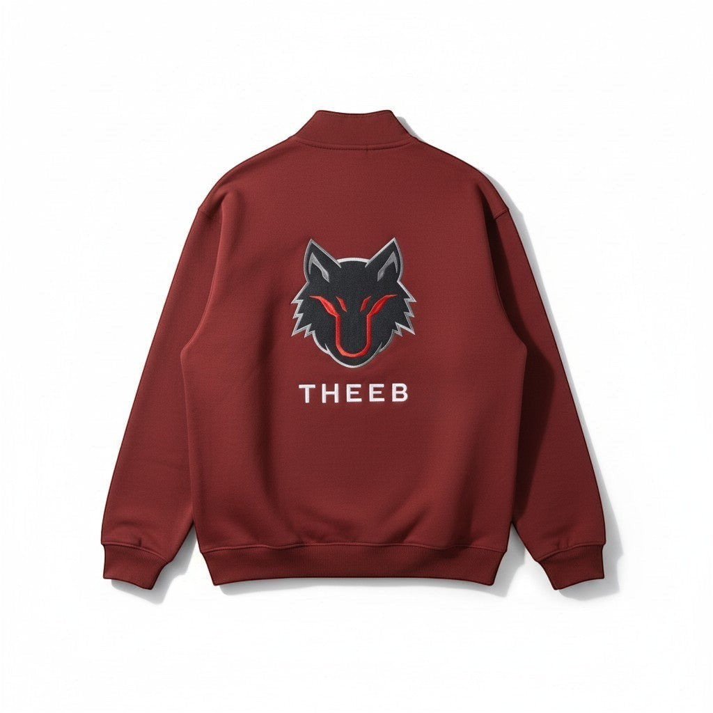 My Store THEEB maroon zip-up workout jacket with stand collar and embroidered wolf logo.