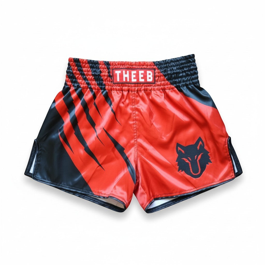 My Store THEEB red and black Muay Thai shorts with wolf head logo and claw marks. Lightweight material for maximum flexibility.