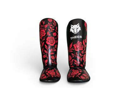 My Store THEEB Rose Fury shin guards in black with red rose pattern, made of PU material for universal sports use.