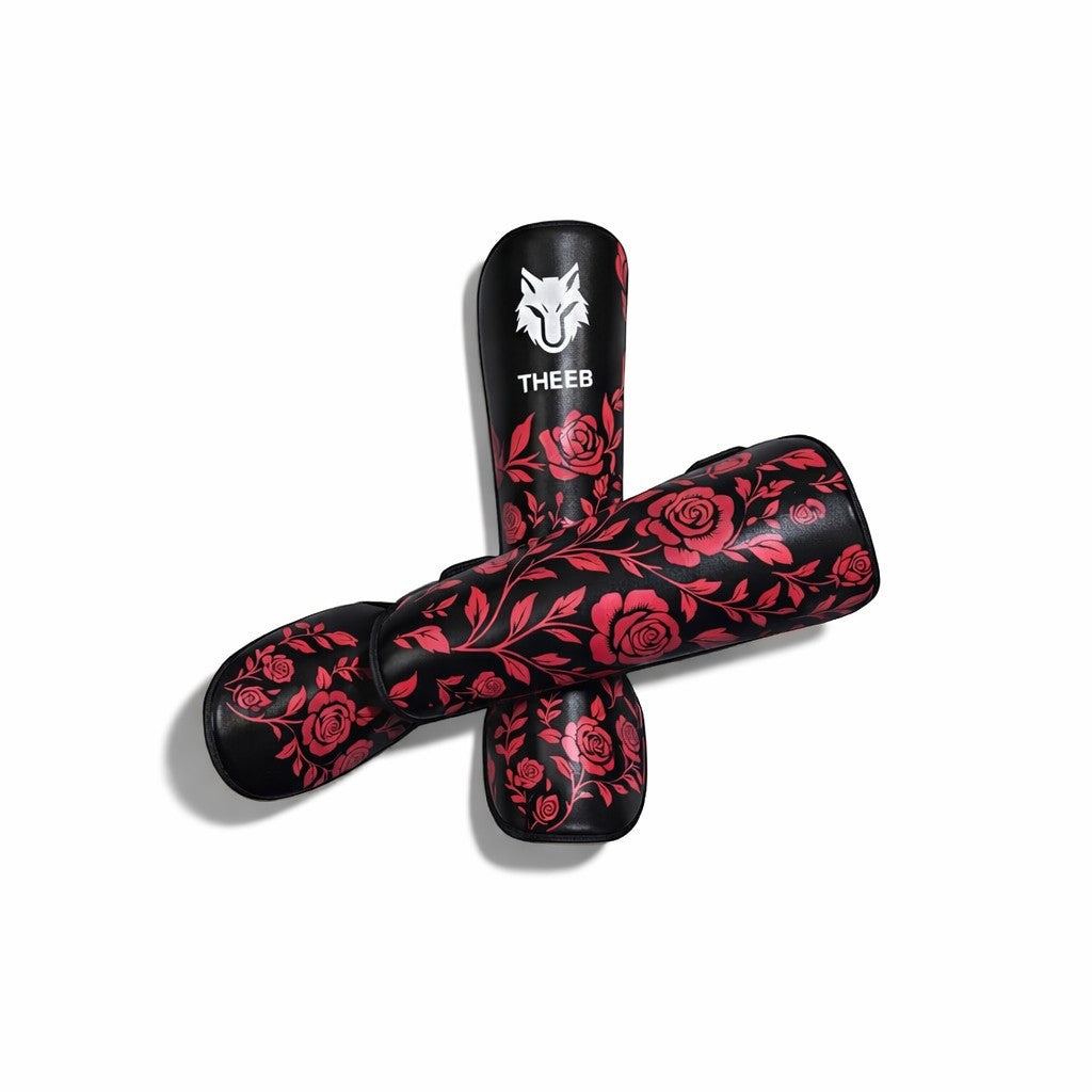 THEEB Rose Fury shin guards in black with a red rose vine pattern, made of PU material for combat sports.