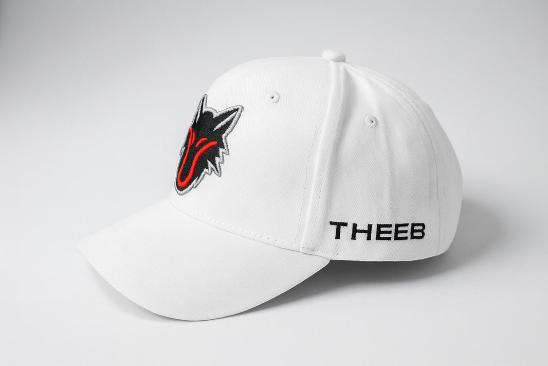 My Store white baseball cap with embroidered black and red wolf head logo and THEEB text on the side.